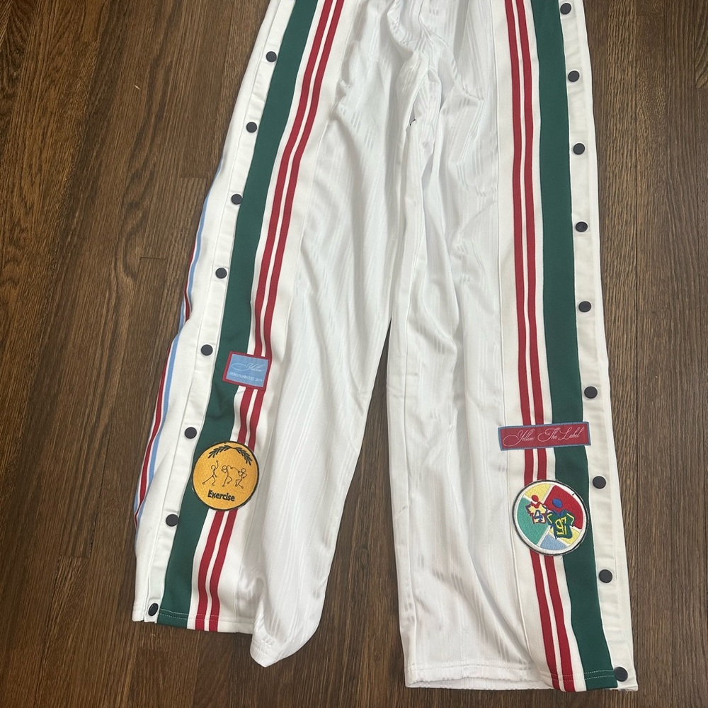 Yellow the label White Track Pants with Red and Green Stripes and side snaps